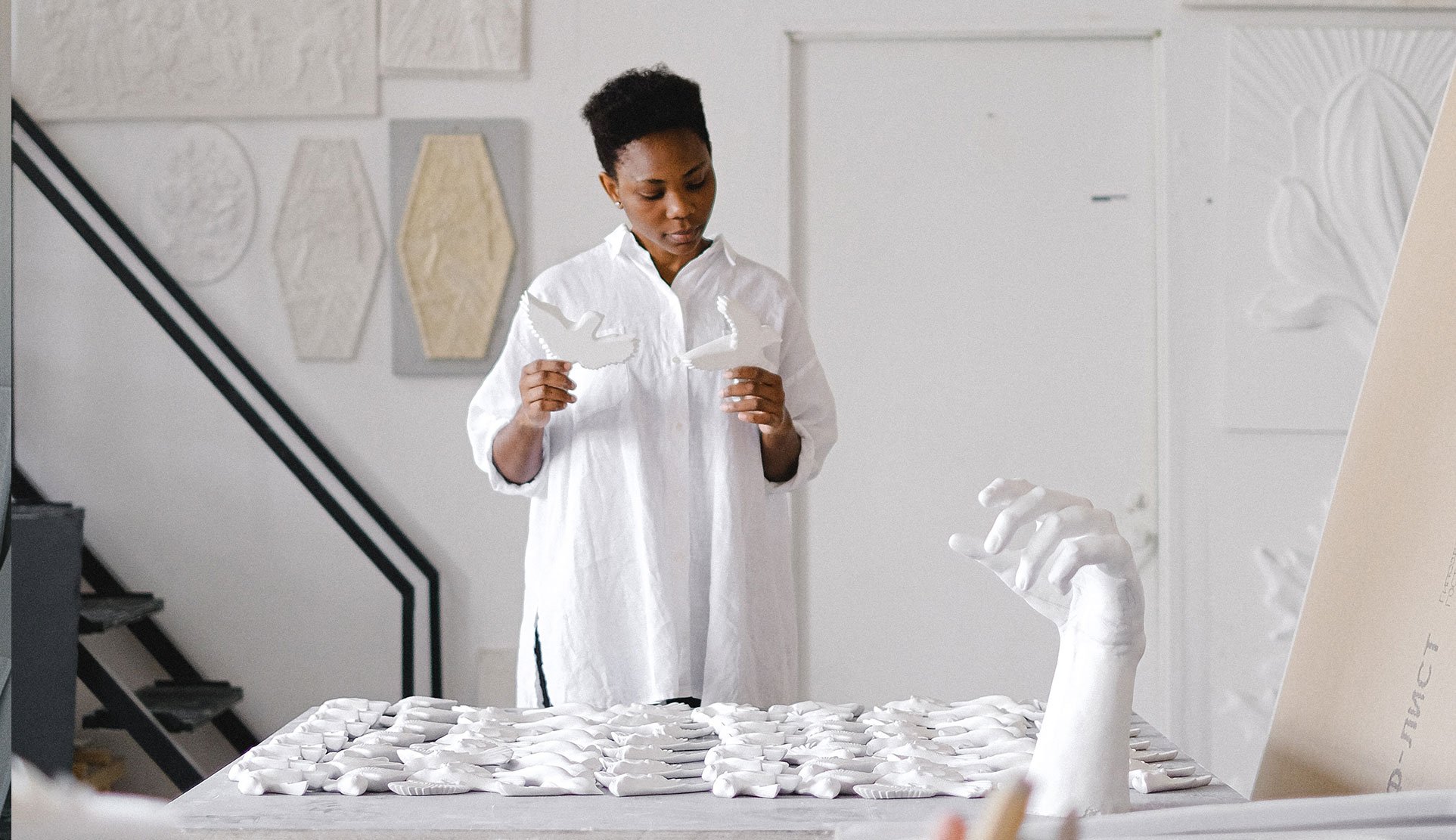 Woman holding ceramic birds hero-14